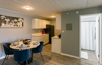 a kitchen and dining room with a table and chairs