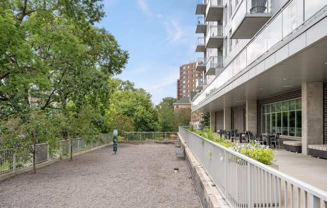 the patio of a building with a fence and trees