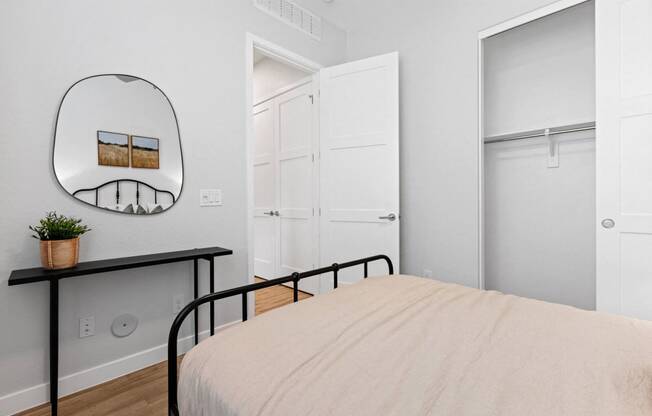 a bedroom with a bed and a mirror and closets at Village of Chandler Apartments, Chandler, 85249