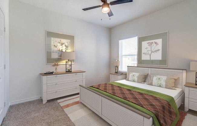 a bedroom with a bed and a ceiling fan