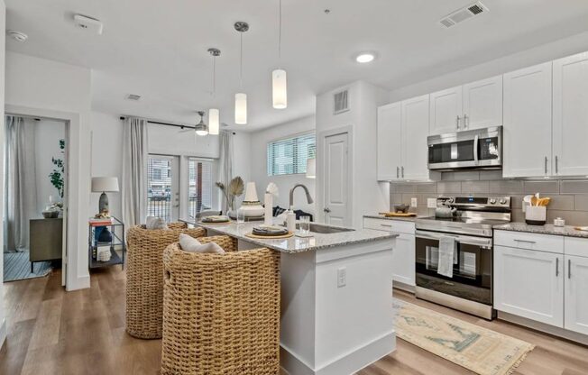 an open kitchen and living room with a table and chairs