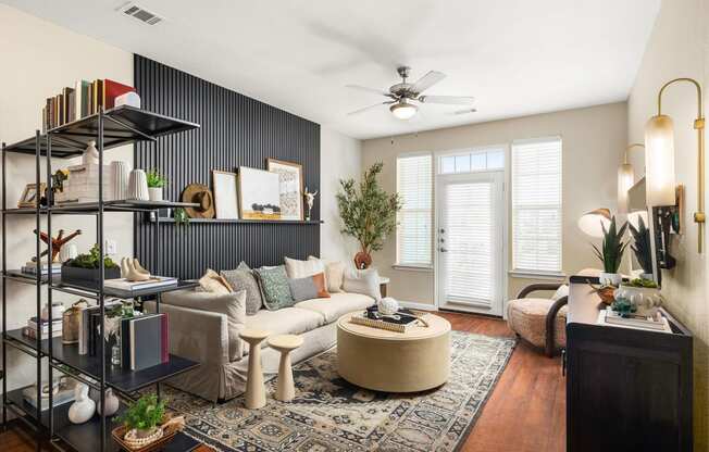 a living room with a white couch and a ceiling fan