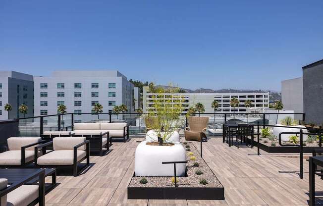 A rooftop patio with a wooden floor and furniture at Skylar At Sunset Apartments, Los Angeles, CA, 90027