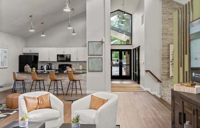 A modern living room with a bar area and a staircase.
