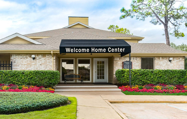 the entrance to the welcome home center in a brick building