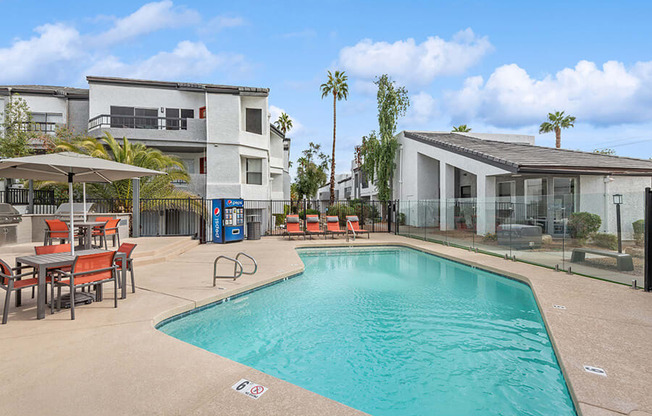 Community Swimming Pool with Pool Furniture at Crystal Creek Apartments in Phoenix, AZ.