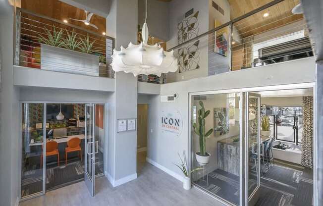 A modern office space with glass walls and a white ceiling light.