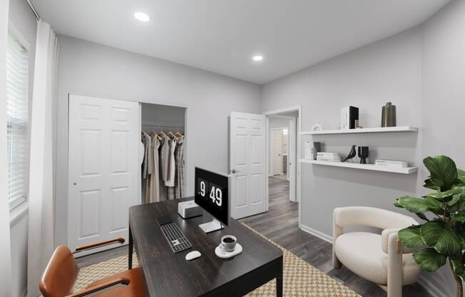 a home office with a desk and a closet