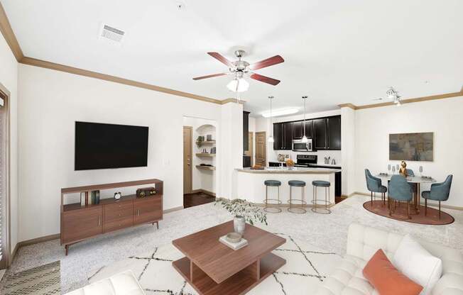 A living room with a white couch and a wooden coffee table.