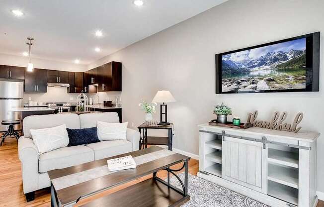 a living room and kitchen with a couch and a table. Circle Pines, MN Lexington Lofts