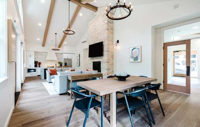A modern dining room with a wooden table and chairs.