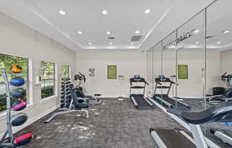 a gym with treadmills and other exercise equipment at the enclave at woodbury