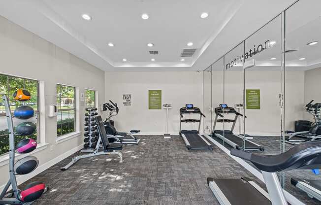 a gym with treadmills and other exercise equipment at the enclave at woodbury