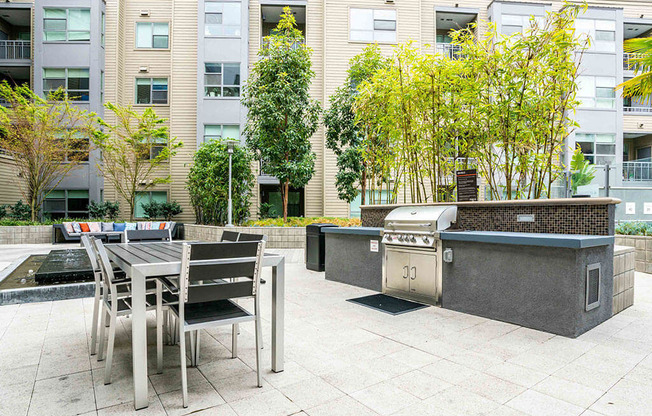 Outdoor Barbecue Area With Grill and Sleek Black Table and seats