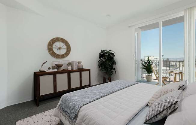 A bedroom with a large bed and a clock on the wall.