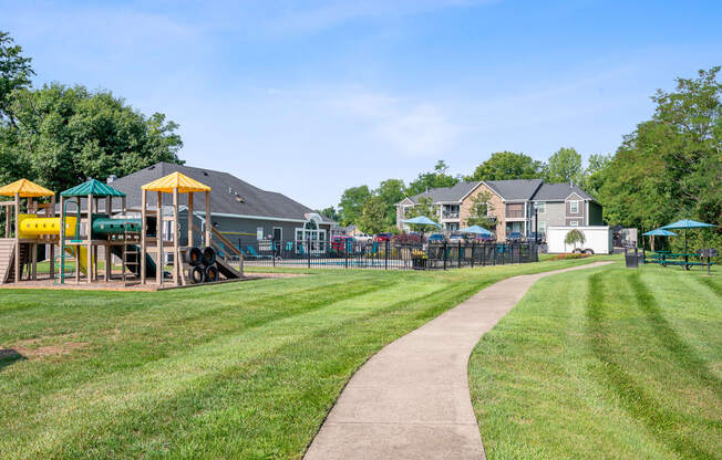 a park with a playground and houses in the background