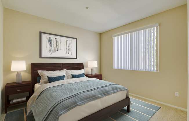 a bedroom with a large bed and two night stands with lamps