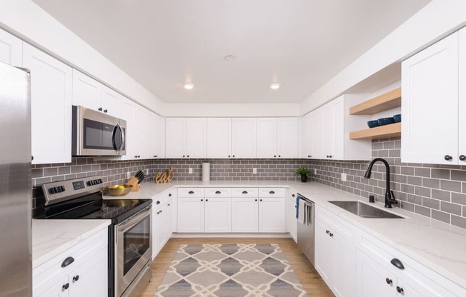 Fully-equipped kitchens with white shaker cabinetry and oil-rubbed bronze hardware package