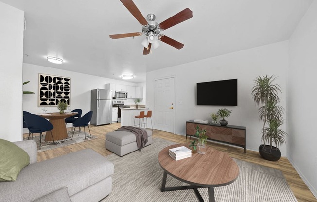 a living room with a ceiling fan and a flat screen tv