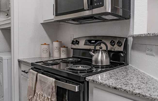 a kitchen with stainless steel appliances and white cabinets