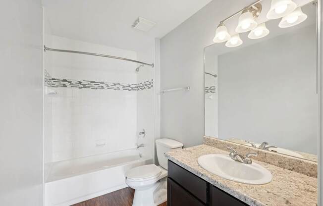 A white toilet sits next to a sink in a bathroom.