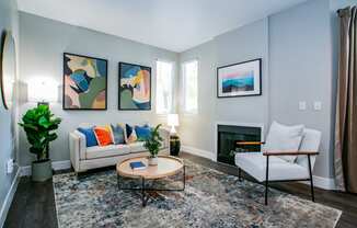 Octave Apartments a living room with gray walls and a fireplace at Octave Apartments, Nevada, 89123