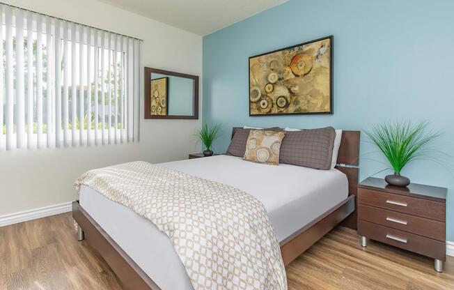 a bedroom with a bed and desk in a room