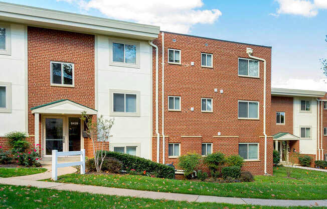 A brick building with a white door and windows.