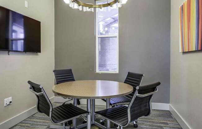 a conference room with a round table and chairs at Echo Park at Perry Crossing Apartments, Plainfield