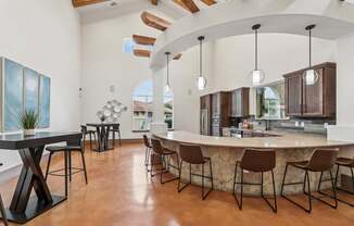 A modern bar and dining area inside the resident lounge at Creekside on Parmer Lane Apartments in Austin, TX