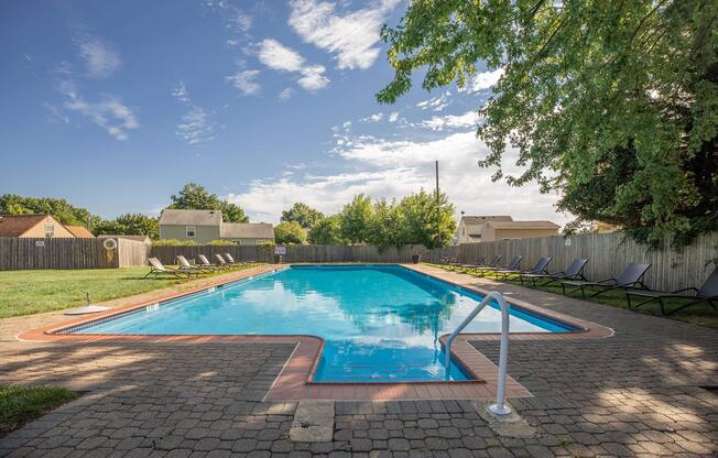 a couple of lawn chairs sitting on top of a sandy beach