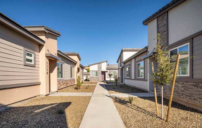 a pathway between a row of houses at Grandstone at Sunrise, Peoria, AZ
