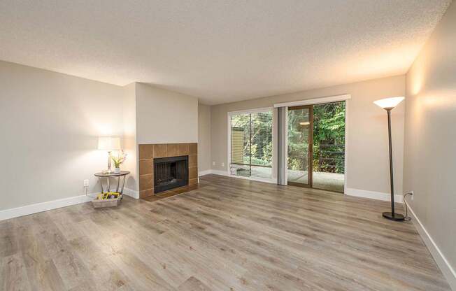 A room with a fireplace and sliding glass doors.