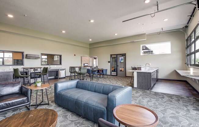 Community Room with a couch and tables and a kitchen