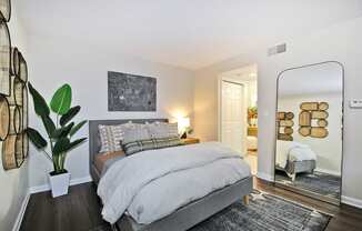 a bedroom with a bed and a mirror