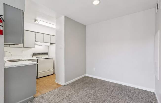 A small kitchen with white appliances and a white countertop.