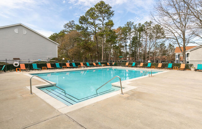 the swimming pool at our apartments has a resort style pool and lounge chairs