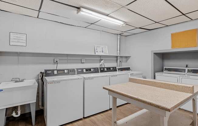 a kitchen with white appliances and a table