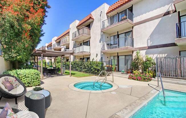 a swimming pool in front of an apartment building  at Sherway Villa, Reseda, CA