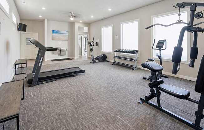 A spacious home gym with a variety of exercise equipment.