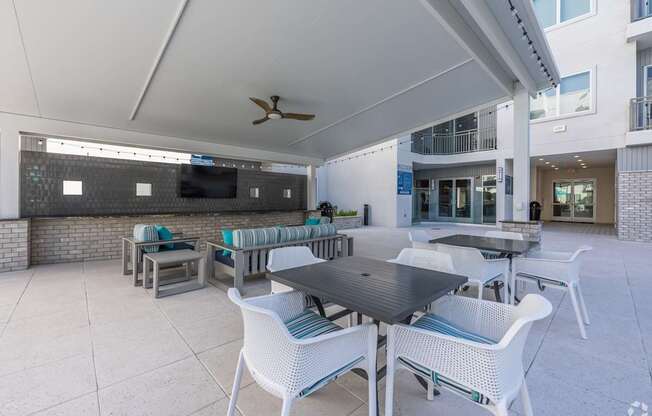 A patio with a table and chairs under a white awning.