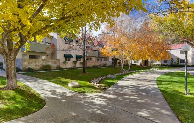 a pathway through the West Oaks community with trees and Apartment buildings in the background