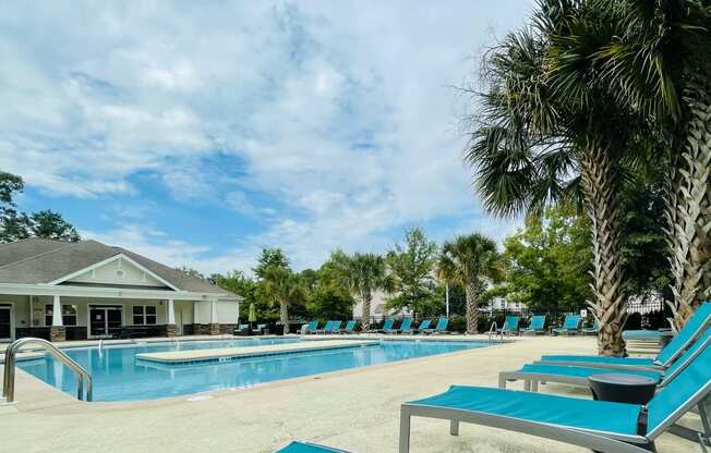 Beautiful pool with loungers at Oasis at Cedar Branch in Wilmington, NC