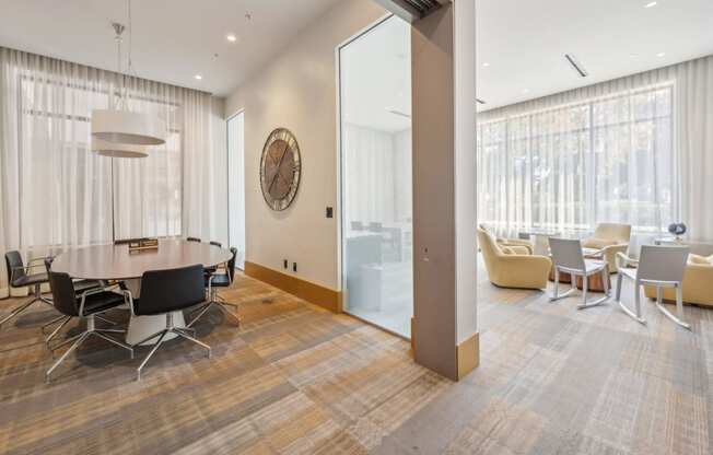 a conference room with a table and chairs and a large window at The Merc, Waltham, 02453