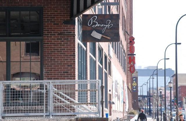 A street view with a building that has a sign that says "Bonzo".