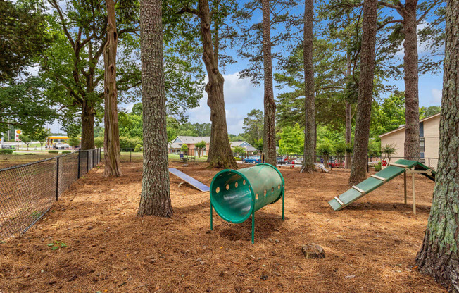 a playground with a slide and a seesaw in a park