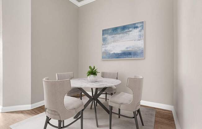 A dining room with a white table and chairs.