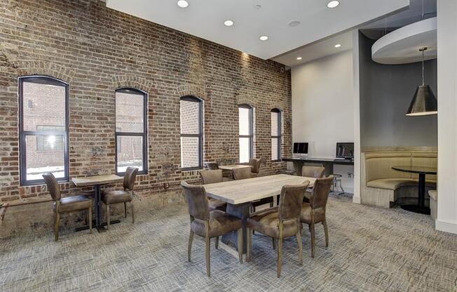 a conference room with a large table and chairs and a brick wall