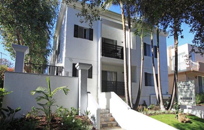 front of building with a garden and stairs to the building