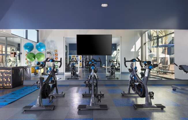 a spacious fitness center with treadmills and exercise bikes